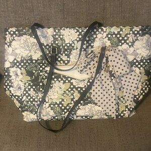 This is a Betsey Johnson black floral tote bag with a removable pouch.
